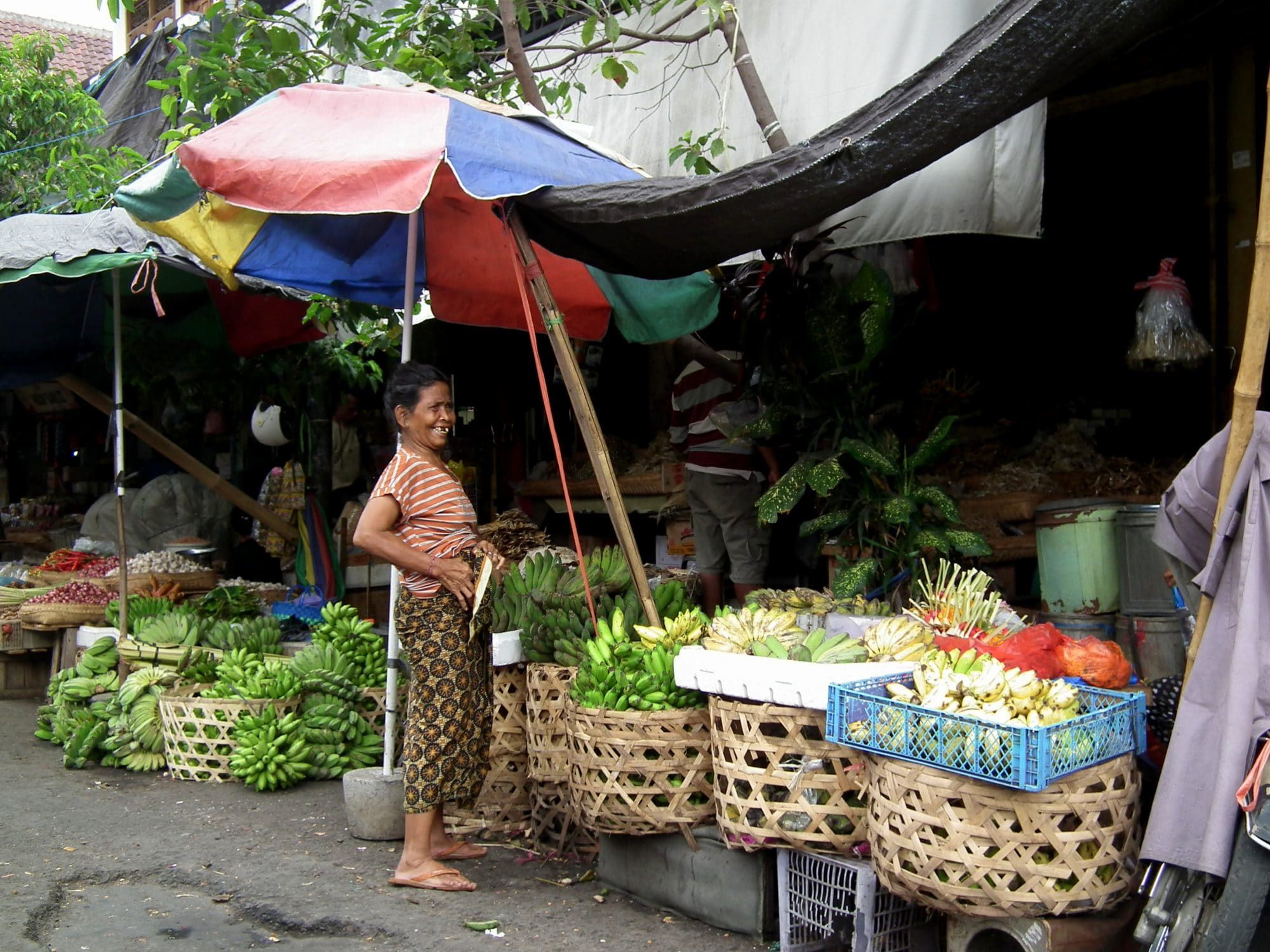 A lively local market with a colourful parasol — day trips and outings arranged from the villa