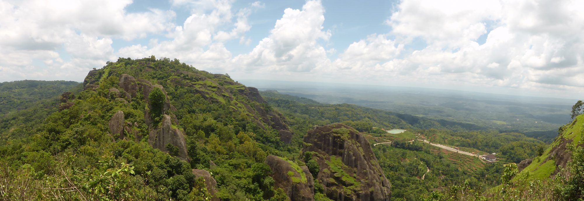 A sweeping view over the green hills and karst landscape around Yogyakarta — day trips from Villa Tanen