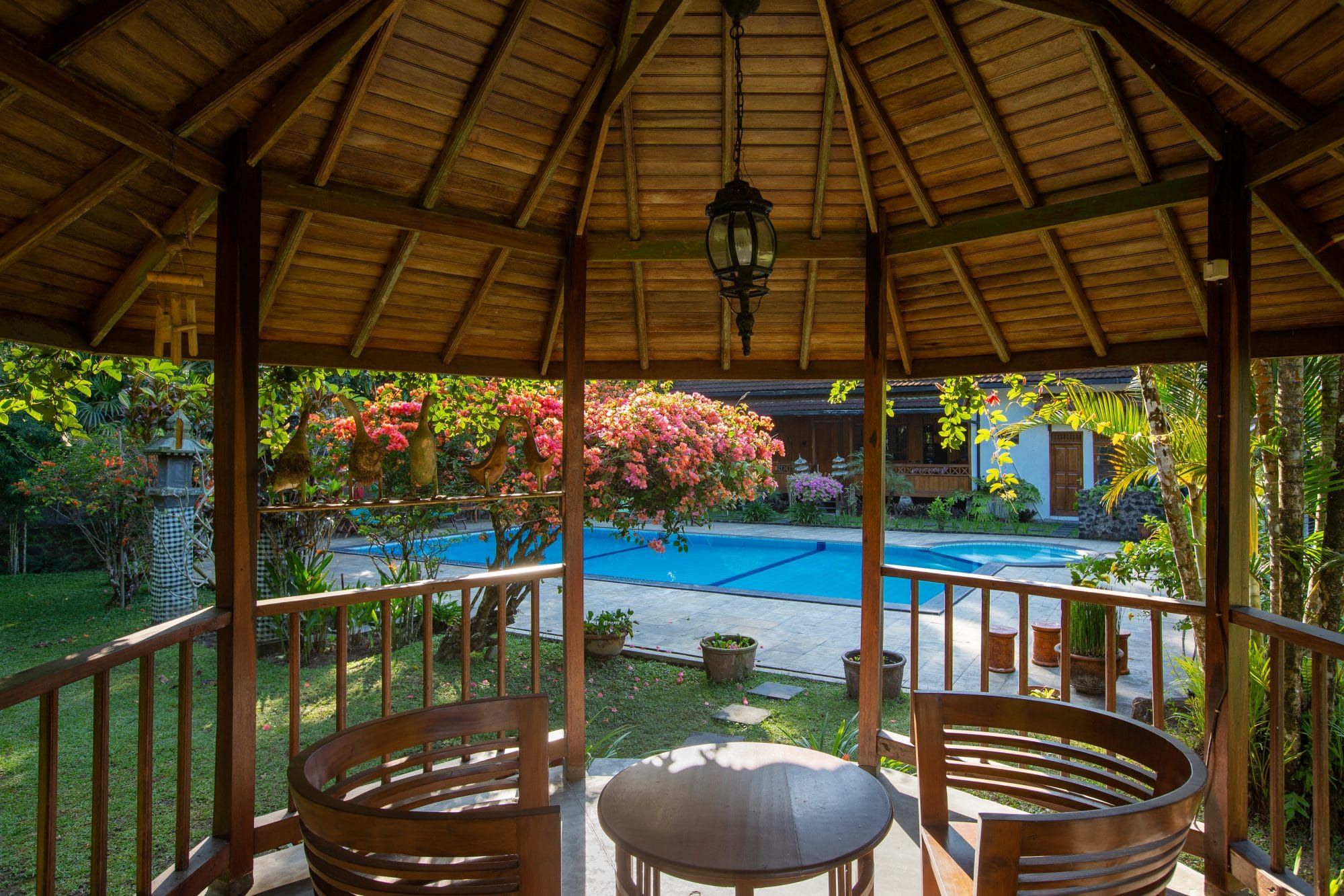 Gazebo overlooking the private pool and flowering tropical garden of Villa Tanen — the real place you book